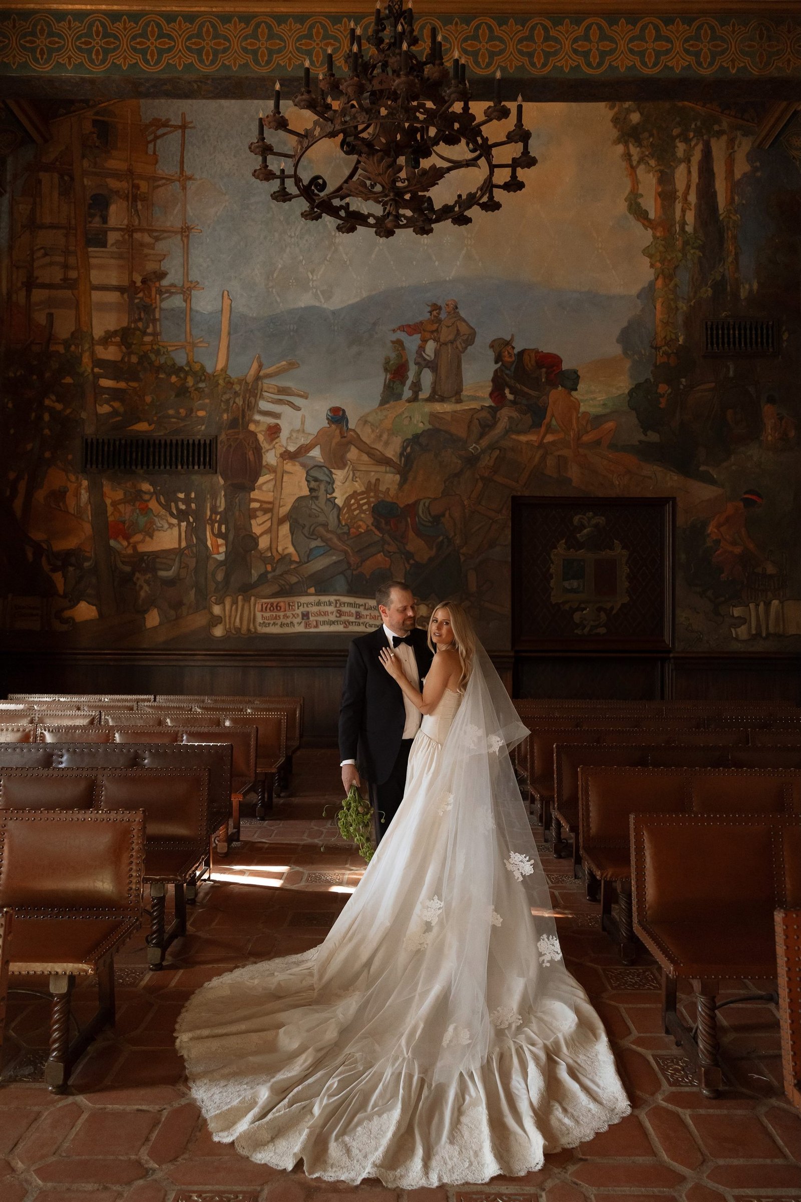 Brittany Casta&ntilde;os and Andrew Medley together in the Mural Room, the train of the Montecito gown sweeping across the tiled floor.